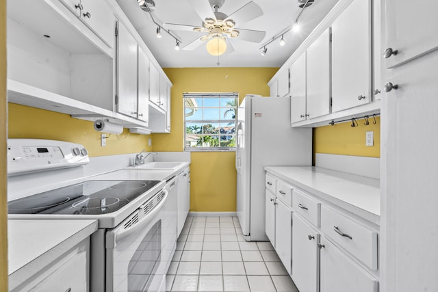 kitchen featuring white appliances, sink, ceiling fan, light tile patterned floors, and white cabinetry