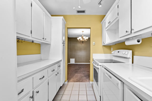 kitchen featuring white appliances, pendant lighting, an inviting chandelier, white cabinetry, and light tile patterned flooring