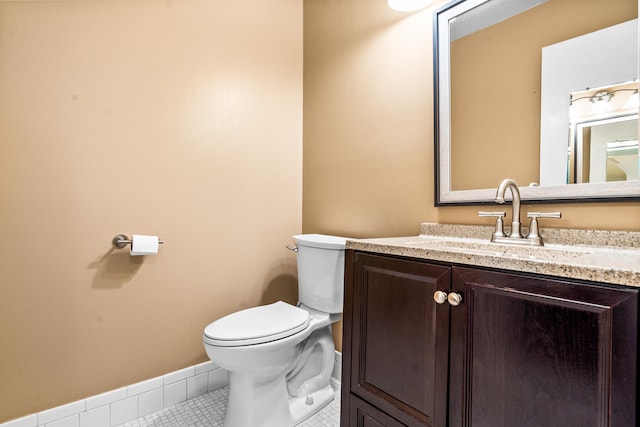 bathroom featuring tile patterned floors, vanity, and toilet