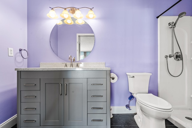 bathroom with tile patterned floors, vanity, toilet, and walk in shower