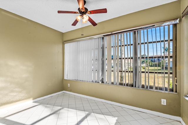 spare room featuring light tile patterned floors and ceiling fan