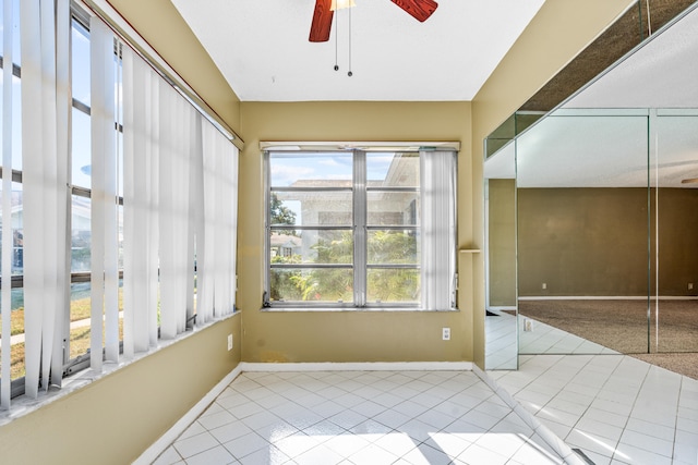 interior space with ceiling fan