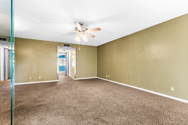 carpeted spare room with ceiling fan and a textured ceiling