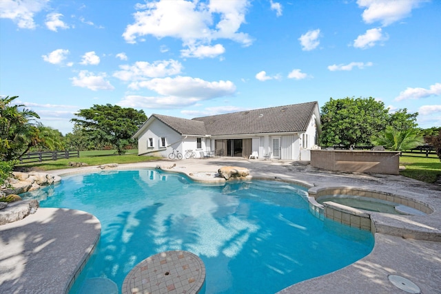 view of swimming pool with a patio and an in ground hot tub