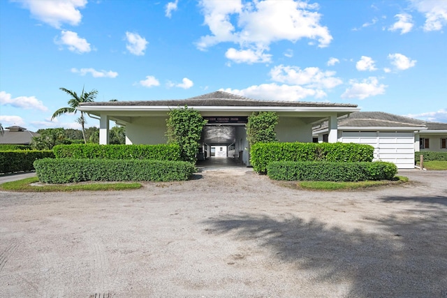 view of front of home with a carport and a garage