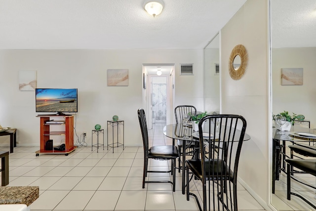 2145 Pierce St Unit 326, Hollywood, FL 33020 - dining room featuring a textured ceiling, light tile patterned floors, and baseboards