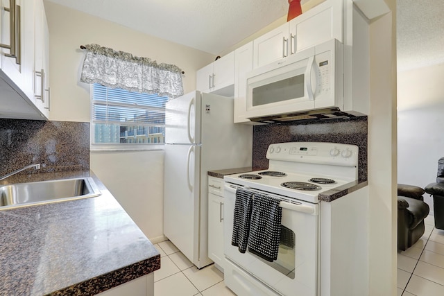 2145 Pierce St Unit 326, Hollywood, FL 33020 - kitchen with white appliances, a sink, light tile patterned floors, white cabinets, and dark countertops