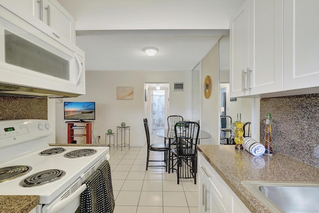 2145 Pierce St Unit 326, Hollywood, FL 33020 - kitchen with white appliances, tasteful backsplash, white cabinets, and light tile patterned floors
