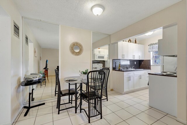 2145 Pierce St Unit 326, Hollywood, FL 33020 - dining space with light tile patterned floors and a textured ceiling