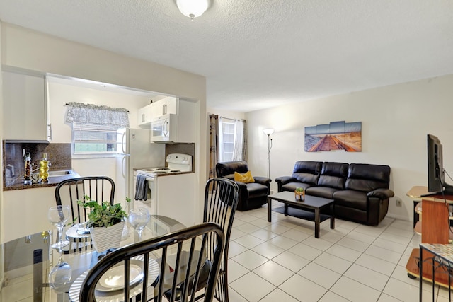 2145 Pierce St Unit 326, Hollywood, FL 33020 - dining area featuring a textured ceiling and light tile patterned flooring