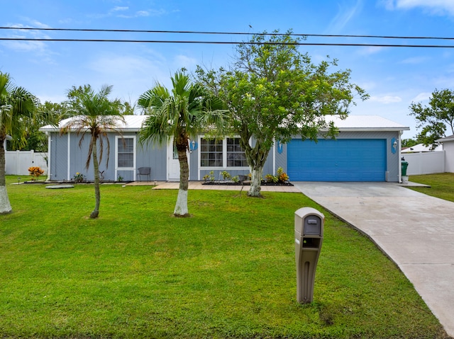 view of front of home with a front lawn and a garage