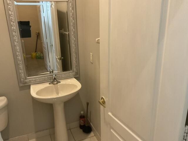 bathroom featuring toilet and tile patterned floors