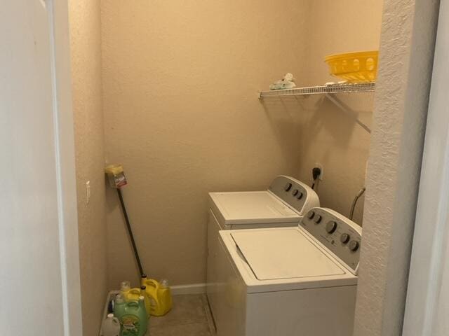 clothes washing area featuring independent washer and dryer and tile patterned flooring