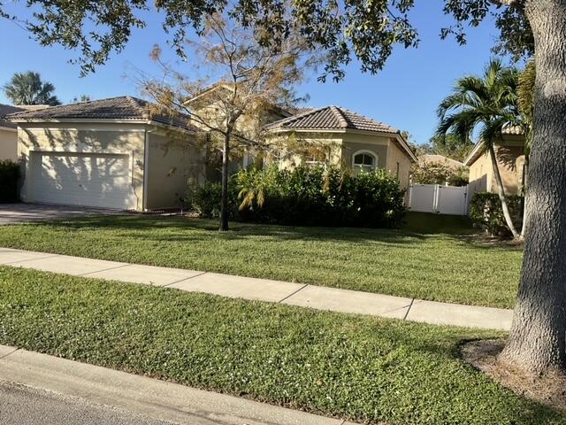 view of front of property with a front yard and a garage