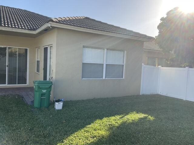 view of property exterior featuring a lawn