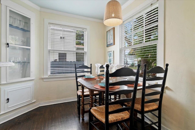 dining area with crown molding and dark hardwood / wood-style floors