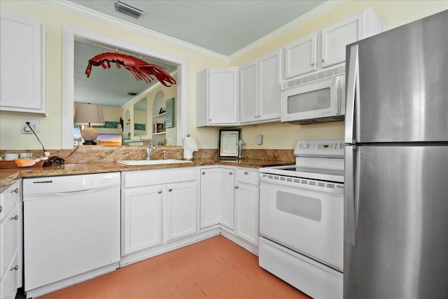 kitchen with white appliances, ornamental molding, sink, and white cabinets