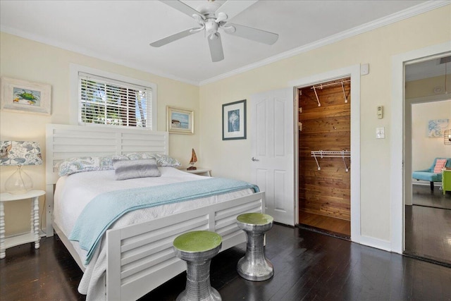 bedroom with dark hardwood / wood-style flooring, crown molding, a closet, and ceiling fan