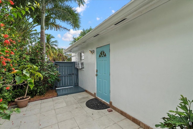 entrance to property featuring a patio