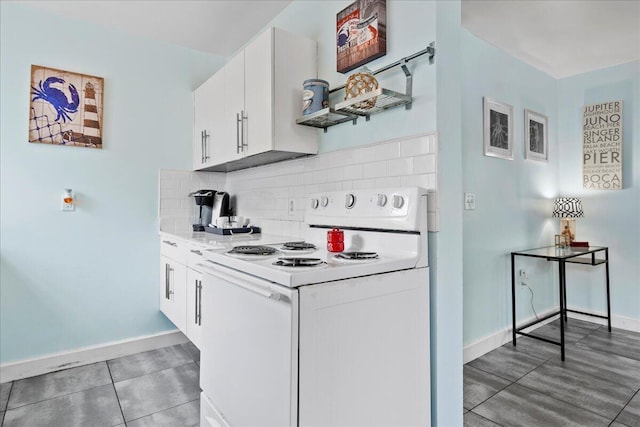 kitchen featuring white cabinetry, decorative backsplash, white range with electric stovetop, and dark tile patterned floors