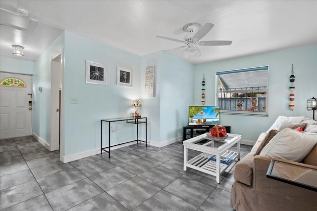 502 39th St, West Palm Beach, FL 33407 - living room with a ceiling fan, baseboards, concrete flooring, and attic access