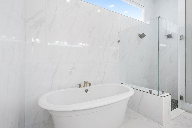 bathroom featuring tile walls and shower with separate bathtub