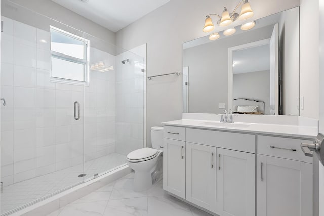 bathroom featuring vanity, toilet, and a shower with door