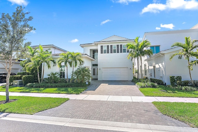 view of front of property featuring a front yard and a garage