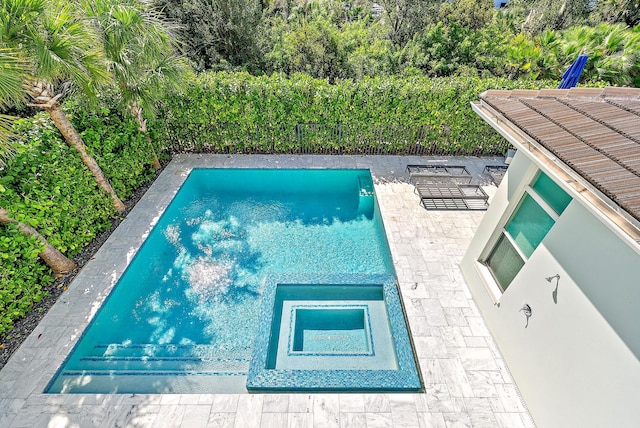 view of pool with a patio and a jacuzzi