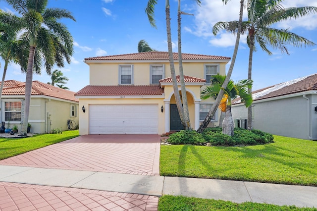 mediterranean / spanish-style house with a front yard and a garage