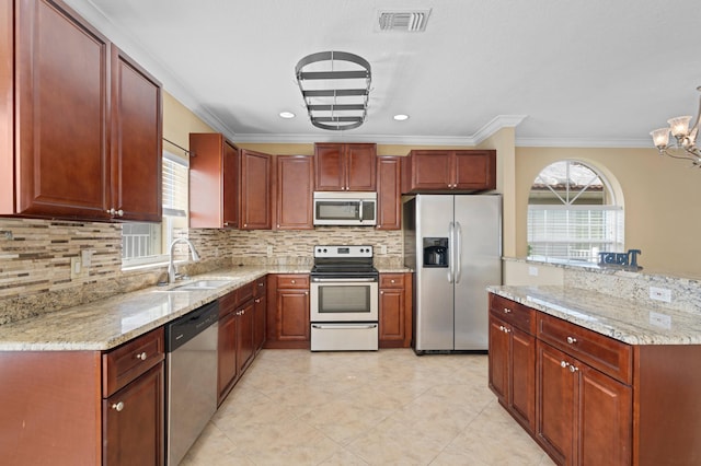 kitchen featuring decorative backsplash, stainless steel appliances, sink, crown molding, and a notable chandelier