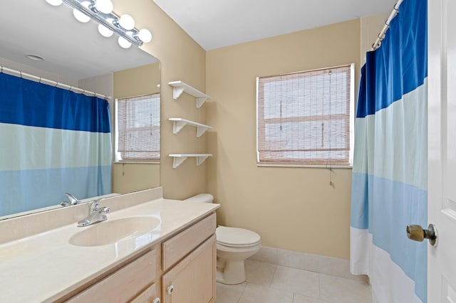 bathroom featuring walk in shower, vanity, toilet, and tile patterned floors