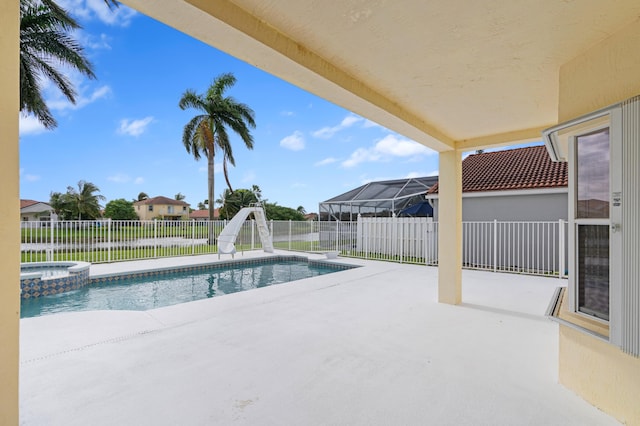 view of swimming pool featuring a water slide, a patio area, and an in ground hot tub