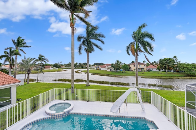 view of pool with an in ground hot tub, a yard, and a water view