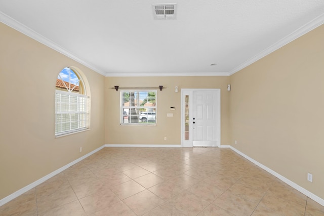 empty room featuring crown molding