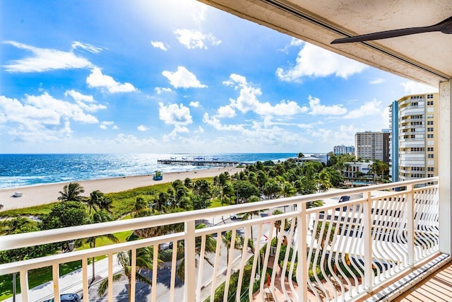 balcony featuring a water view and a beach view