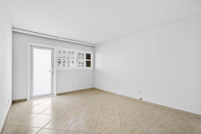 spare room featuring light tile patterned flooring