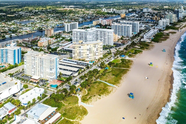 birds eye view of property with a water view and a view of the beach