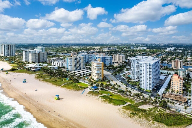 drone / aerial view with a water view and a beach view