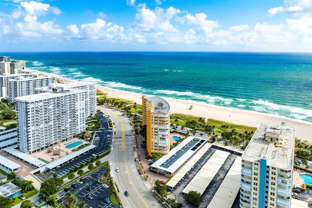 drone / aerial view with a water view and a beach view