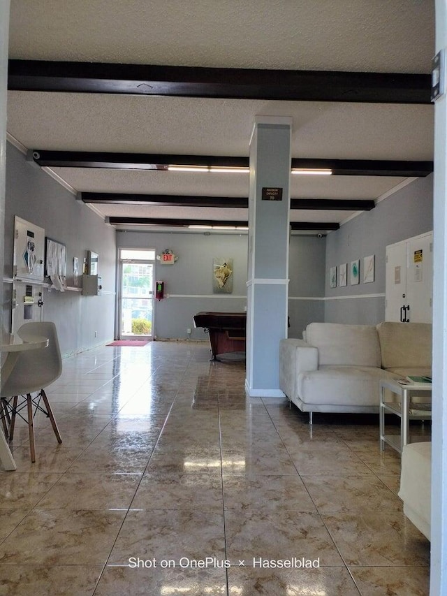 hall featuring beam ceiling and a textured ceiling