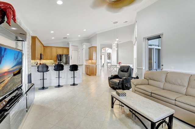 tiled living room featuring ornamental molding and vaulted ceiling