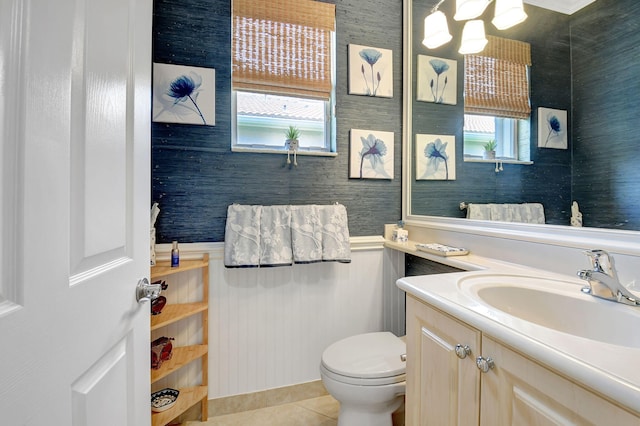 bathroom featuring a wealth of natural light, vanity, toilet, and tile patterned flooring