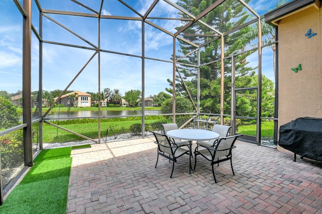 unfurnished sunroom featuring a water view