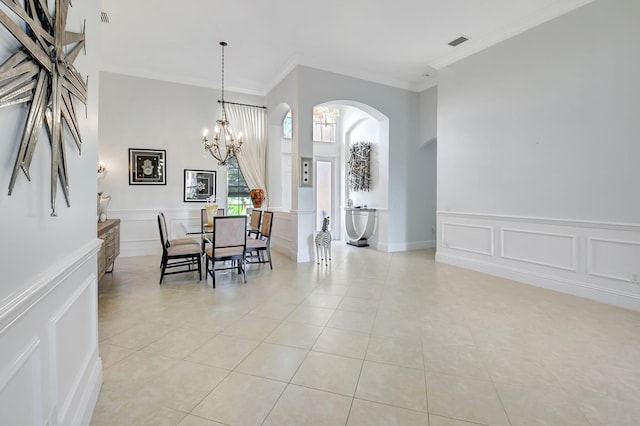 tiled dining space with crown molding and a notable chandelier