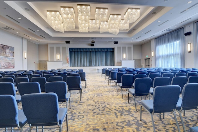 home theater featuring a towering ceiling, an inviting chandelier, and a raised ceiling