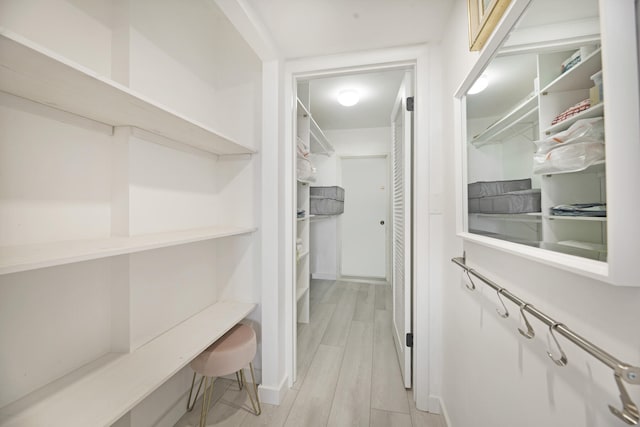 spacious closet featuring light hardwood / wood-style flooring