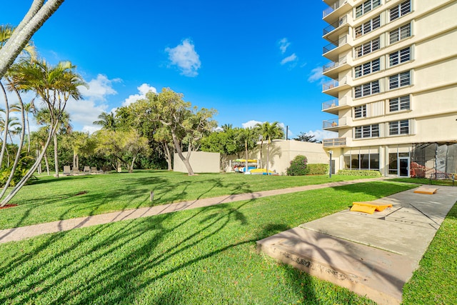 view of property's community with a lawn