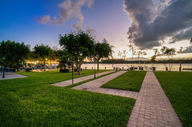 surrounding community with fence and a lawn