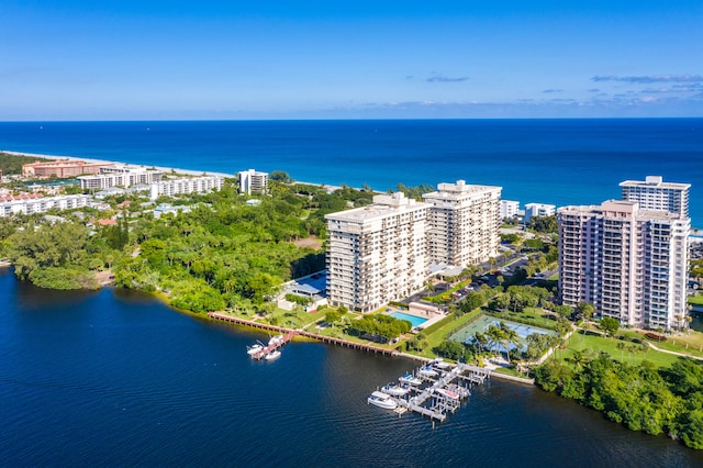 birds eye view of property with a water view and a city view